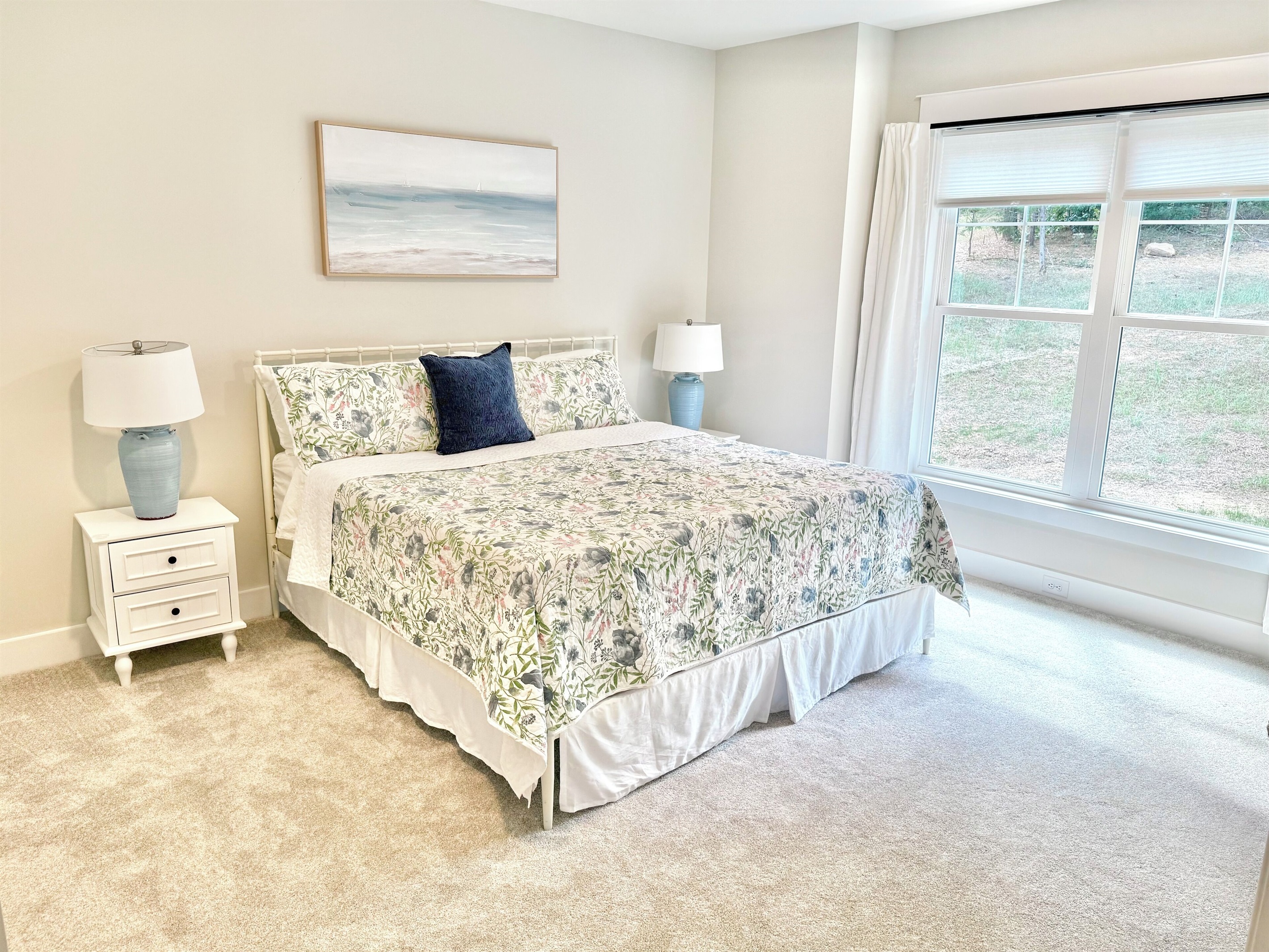 The 2nd main level king suite blends crisp, fun colors with bright, luxurious bedding and a stately antique dresser to add timeless charm to the master suite. We also coordinated the same colors in this master bath to create an inviting retreat.
