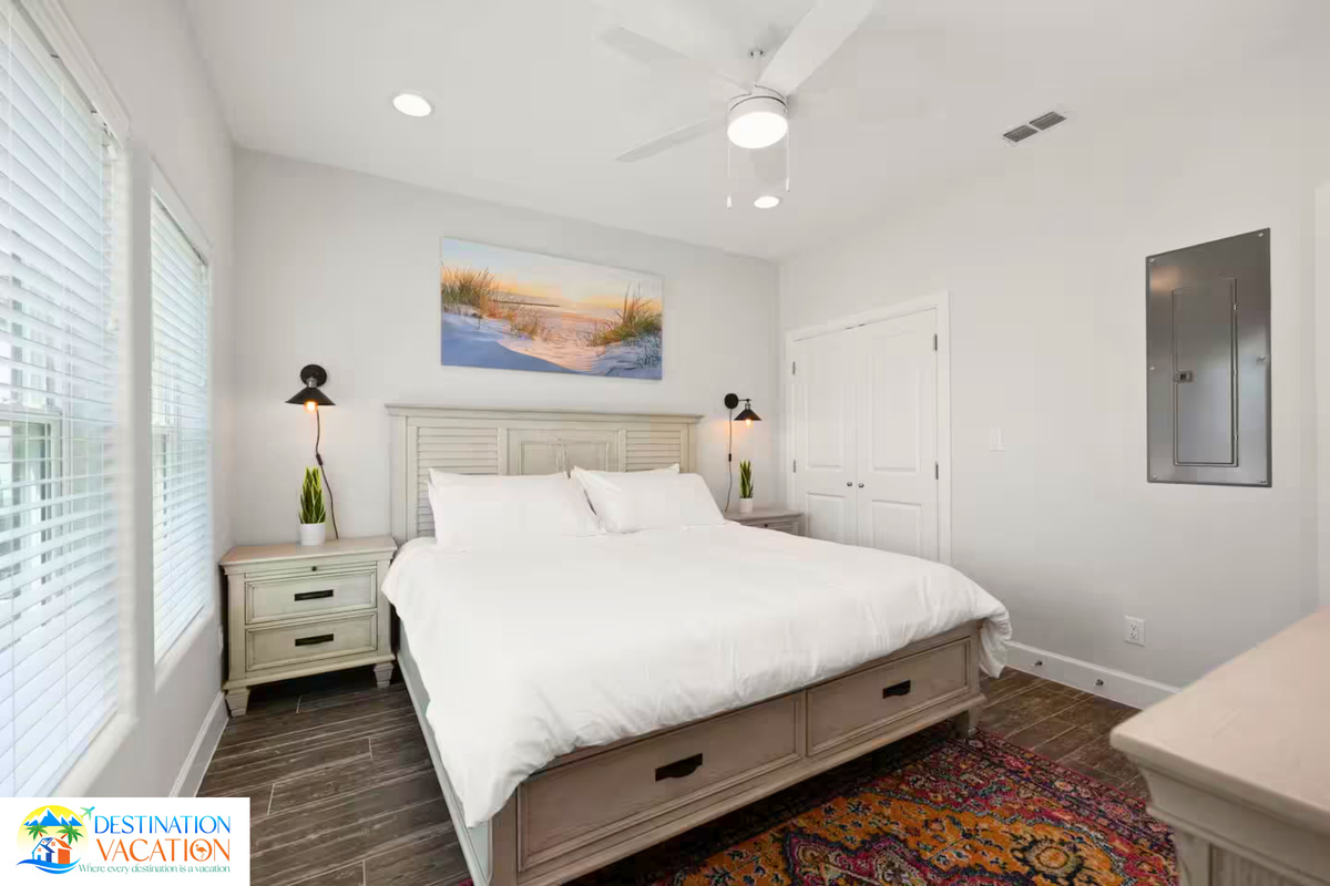 Bright windows and plush bedding create restful comfort.