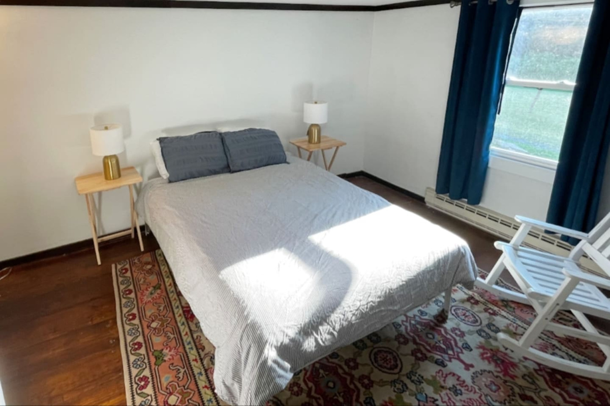Both bedrooms have queen sized beds. One bedroom has a solid door, the bedroom off the living room has a curtain partition.