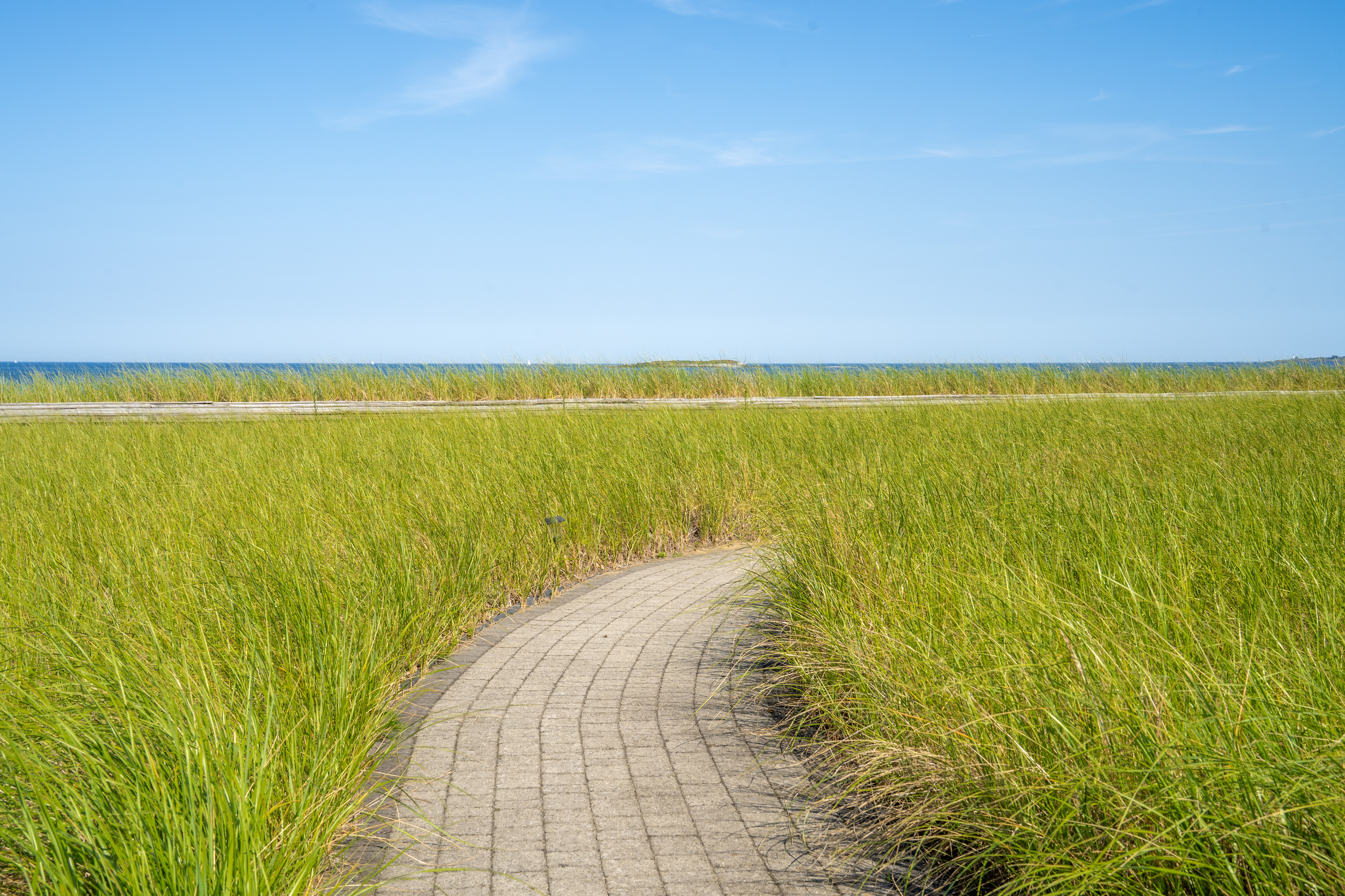 Follow the sandy path through the beach grass toward the ocean and your next day by the water.
