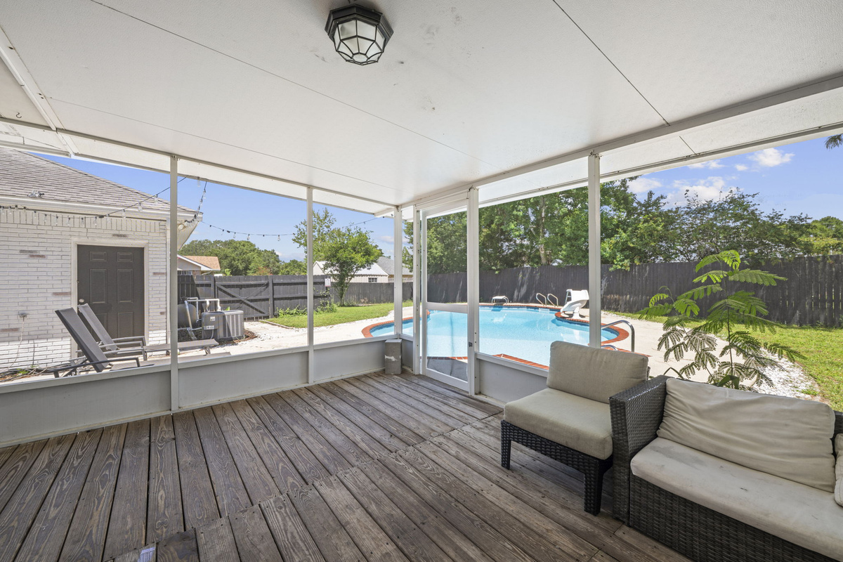 Enjoy the private pool from this covered, bug-free porch with plenty of lounge seating for the whole group.