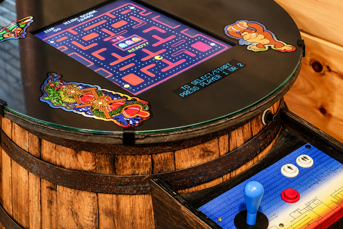 Battle for the high score on a whiskey-barrel arcade table loaded with classics.
