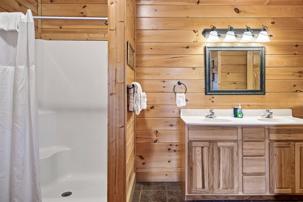 Spacious downstairs master suite bathroom with double sink vanity.