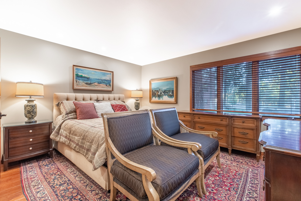 Comfortable Master bedroom with two dressers, Roku television, and en suite bathroom.