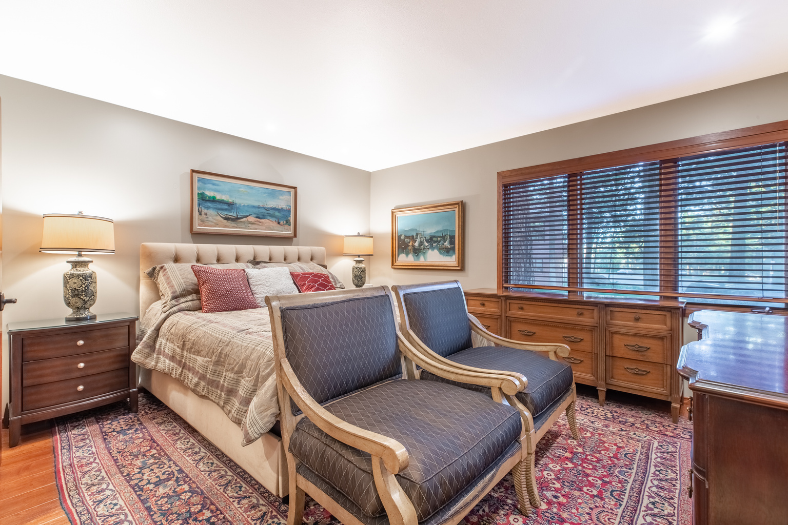 Comfortable Master bedroom with two dressers, Roku television, and en suite bathroom.