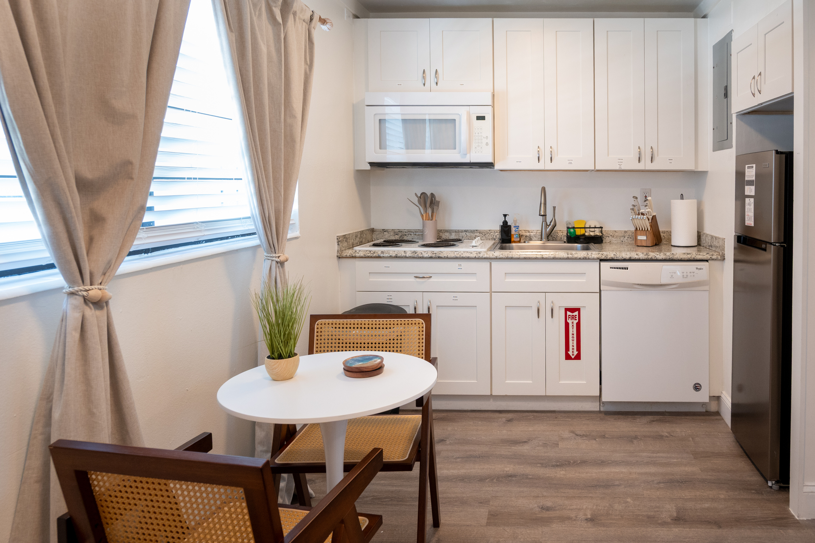 Kitchenette with full-size dishwasher, microwave, full-size fridge, stovetop and bistro table for two