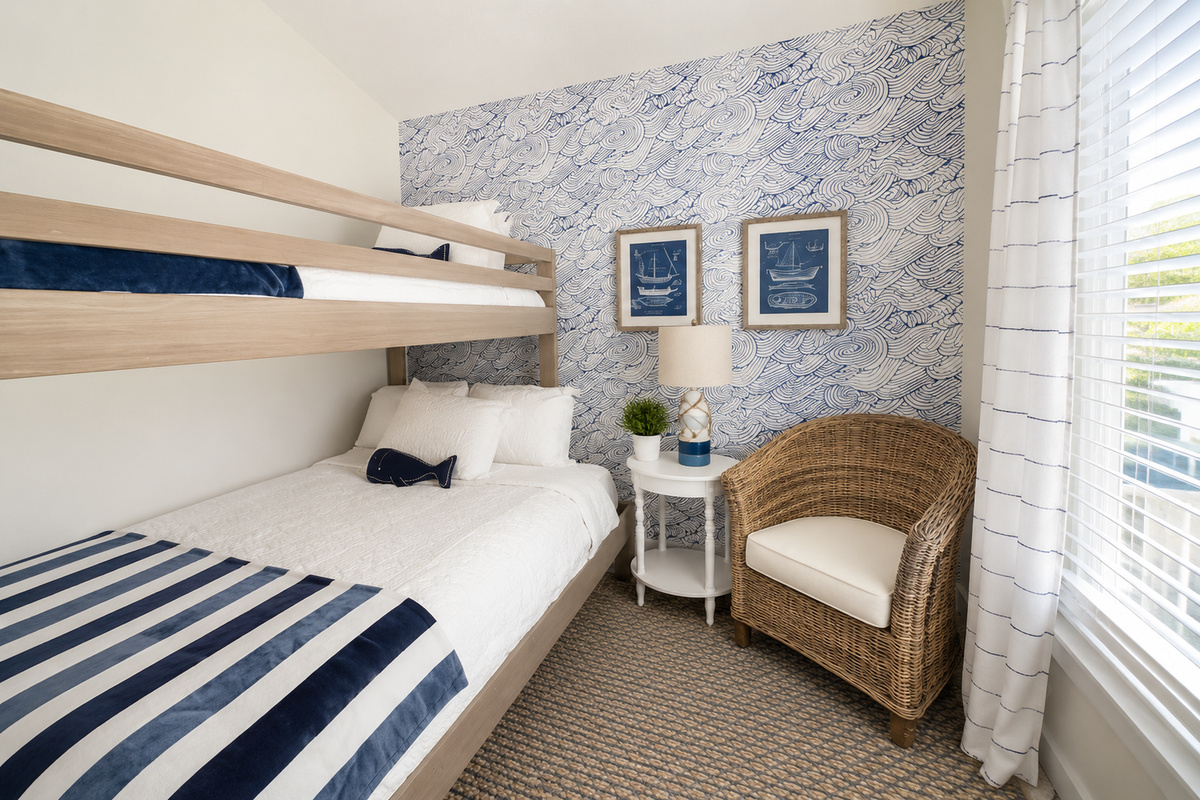 Top bunk or bottom bunk is the only argument you'll hear — the twin-over-full bunk room comes with wave wallpaper, its own TV, and a long white dresser that swallows a week of swimsuits without complaint.