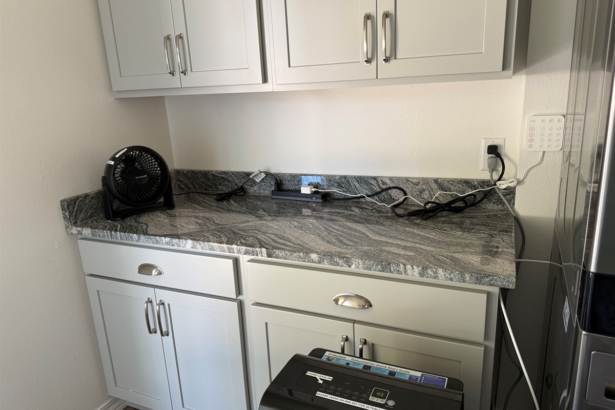 Laundry room cabinets and counter space are necessary for folding and dropping keys somewhere after a long day of excitement.