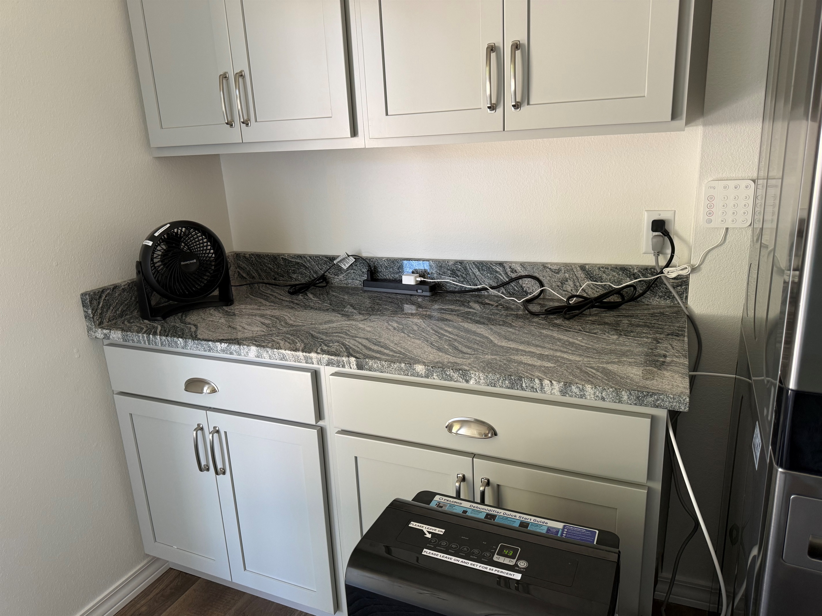 Laundry room cabinets and counter space are necessary for folding and dropping keys somewhere after a long day of excitement.