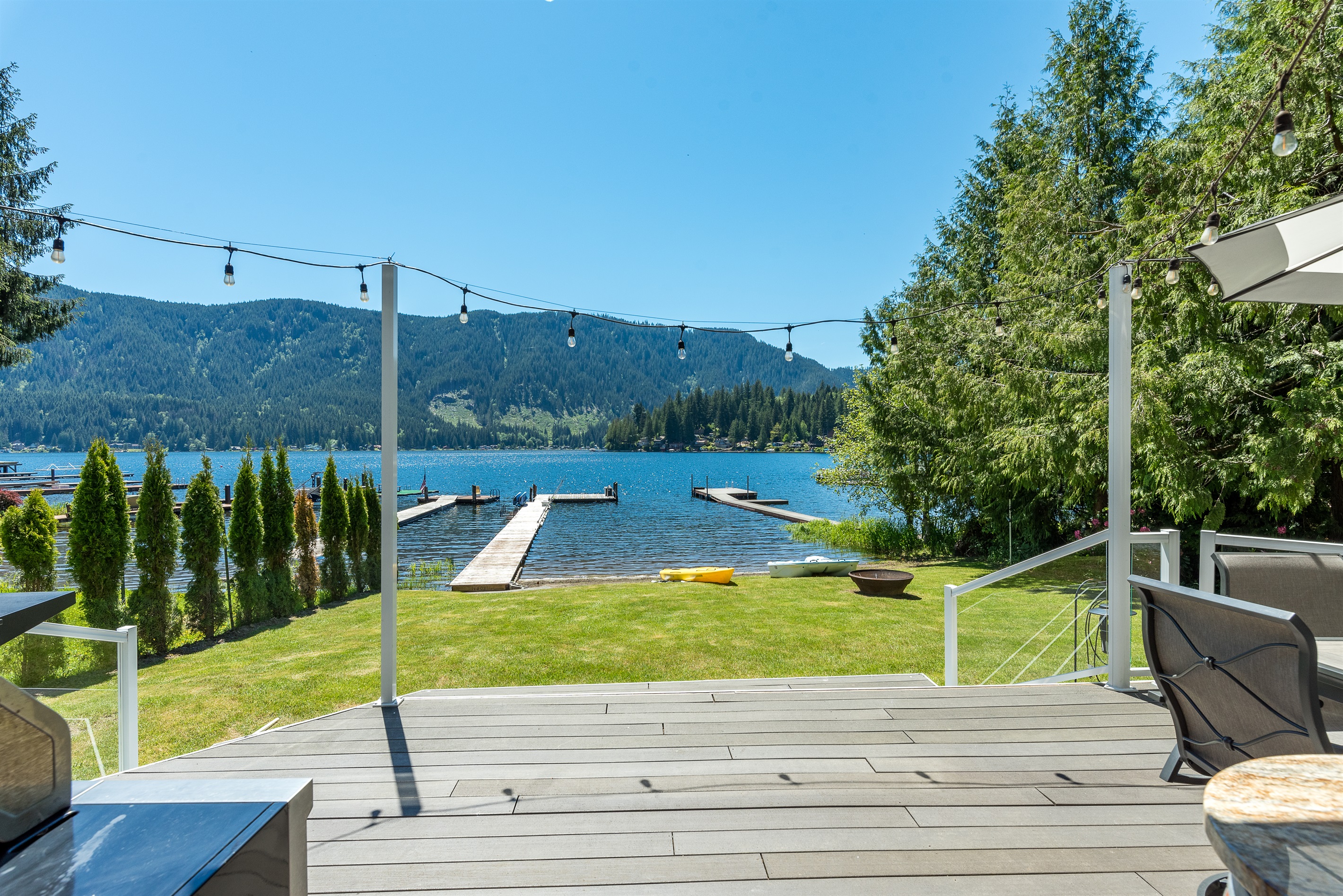 A view of the backyard, dock, and lake access from the main level deck.