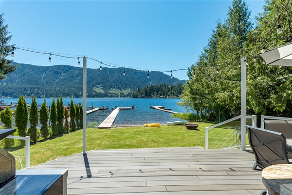 A view of the backyard, dock, and lake access from the main level deck.