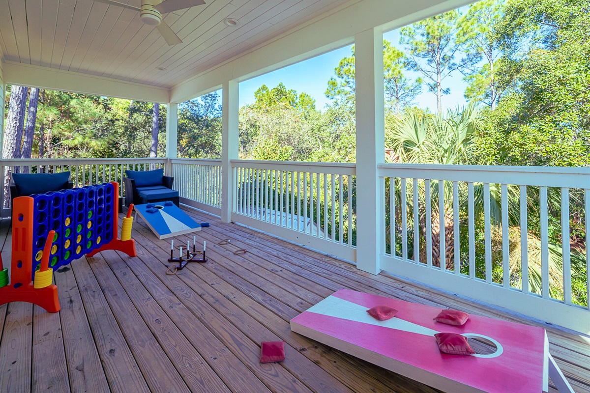 Spacious deck with seating areas, cornhole, and ring toss - perfect for outdoor fun and relaxing evenings