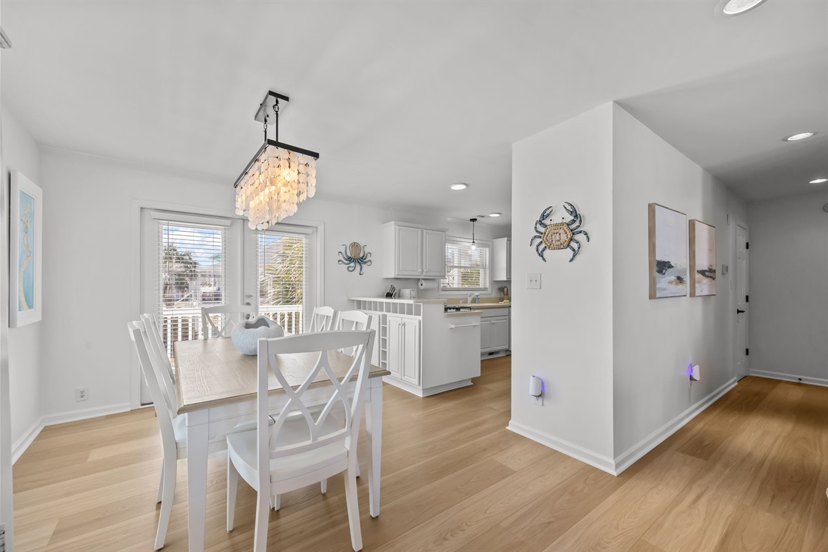 Spacious open layout with dining area, kitchen, and hallway leading to bedroom
