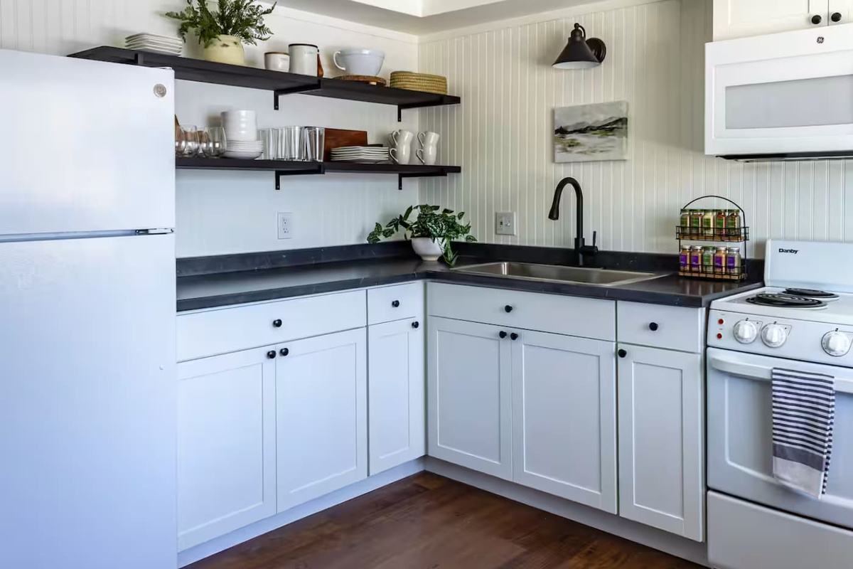 Crisp white cabinetry and open shelving give this kitchen an airy, put-together feel for cooking up something good.