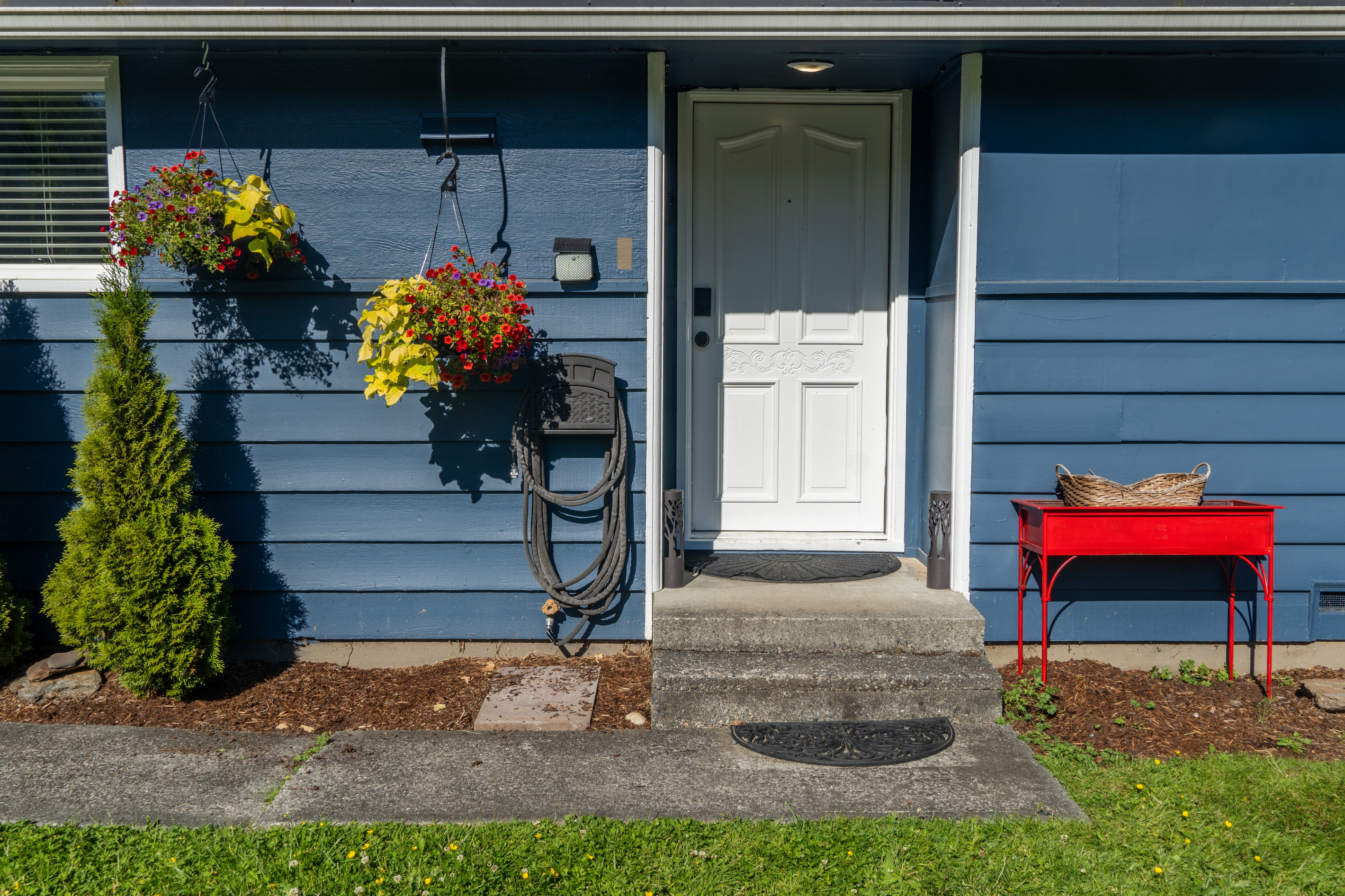 The front door welcomes guests with charm and a hint of the home’s inviting character.