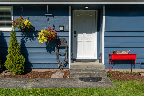 The front door welcomes guests with charm and a hint of the home’s inviting character.