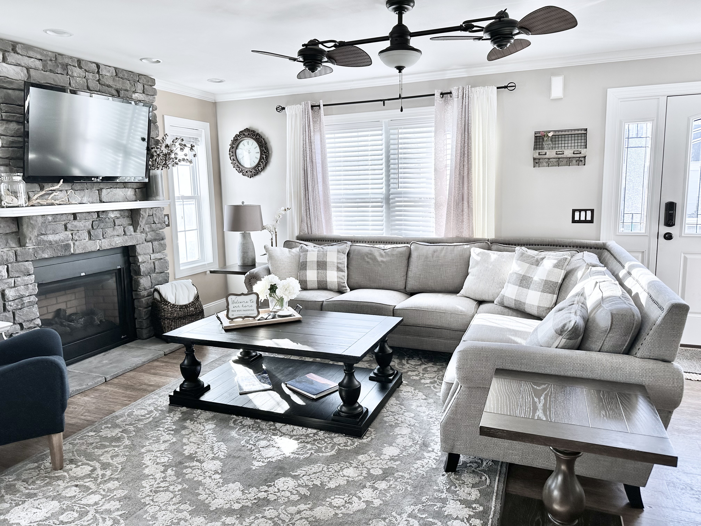 This living room is all about comfort. The big, plush sectional is perfect for sinking into, and the stone fireplace makes the whole room feel so warm and inviting. It’s a bright, open space where you can really just kick back and relax.