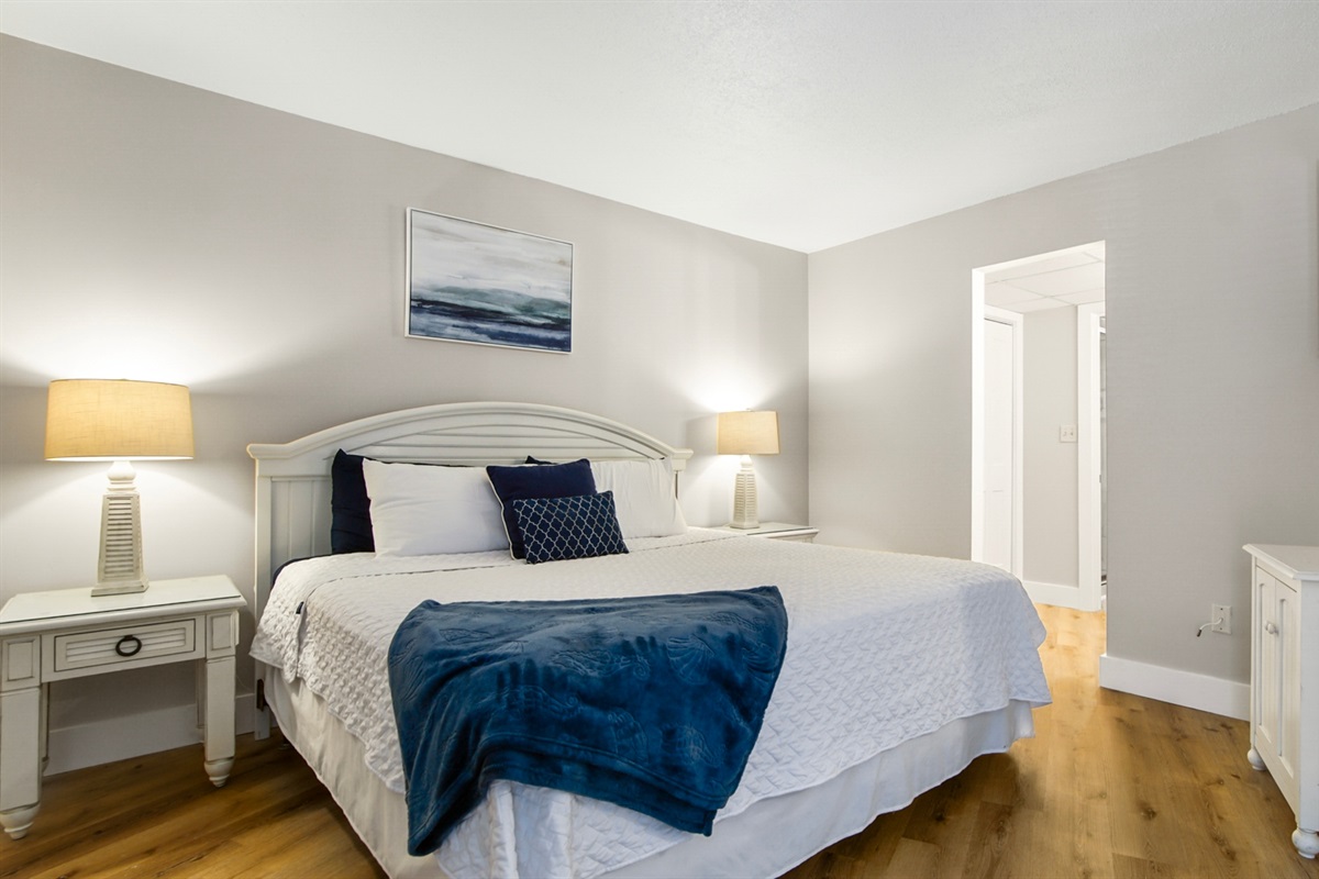 Main bedroom with king bed, ensuite bathroom, smart TV and clothing storage