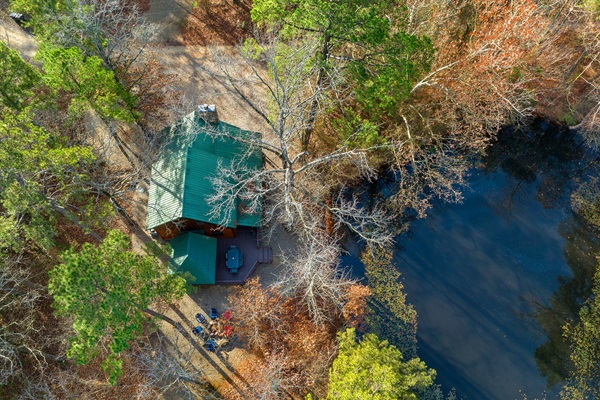 Aerial view of cabin and pond as well as fire pit