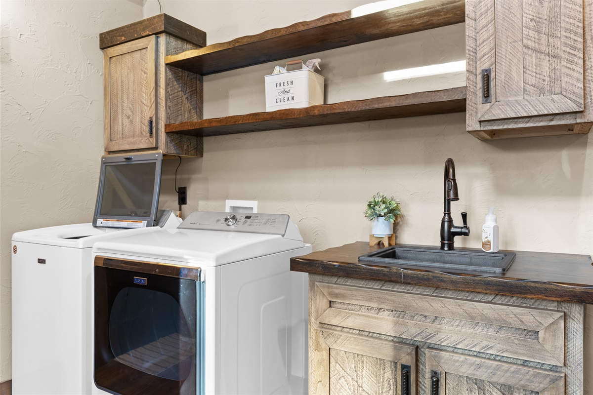 The laundry room is practical and stylish, with modern appliances and plenty of counter space.