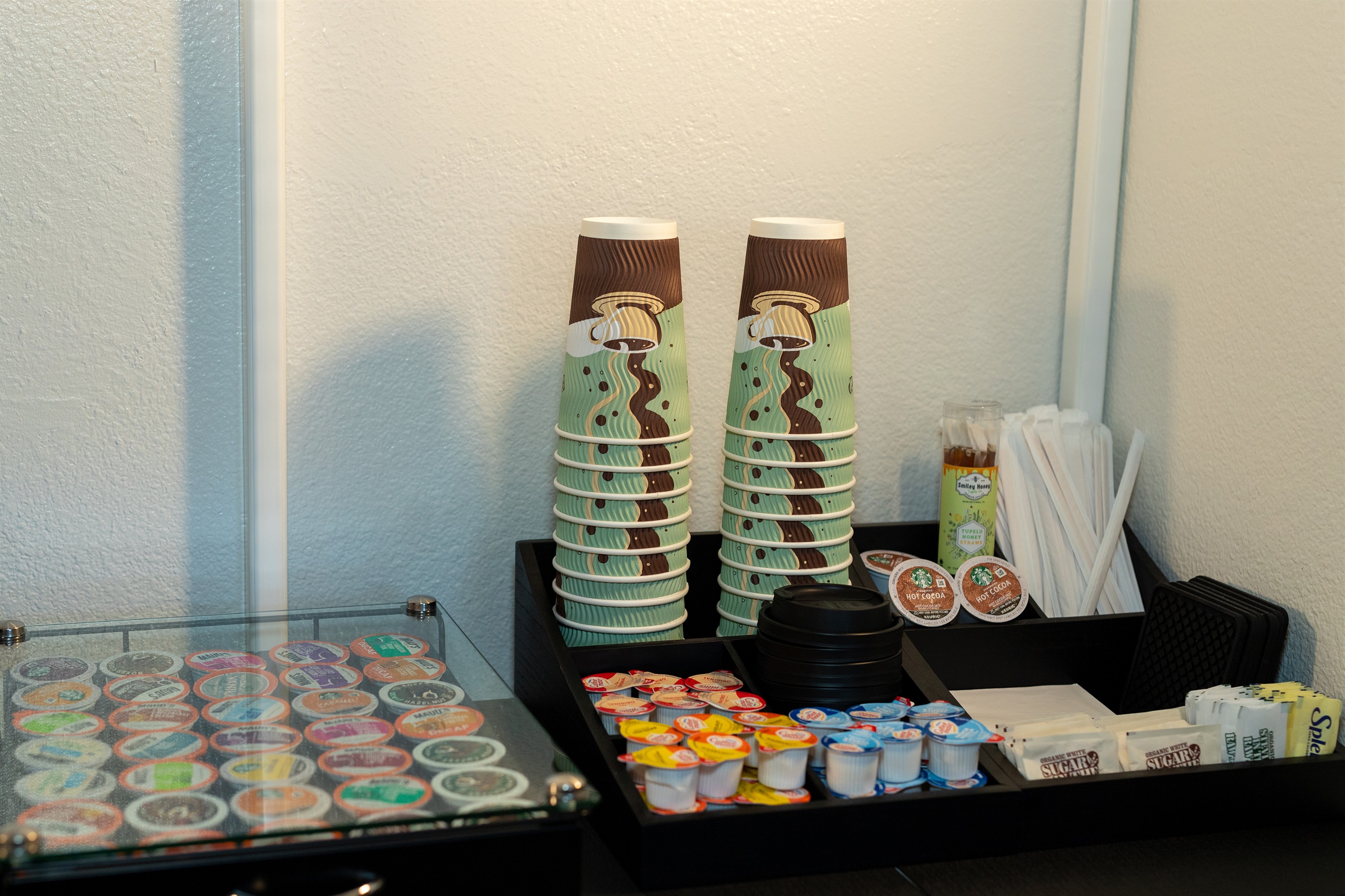 Coffee station with cups, supplies, and morning essentials
