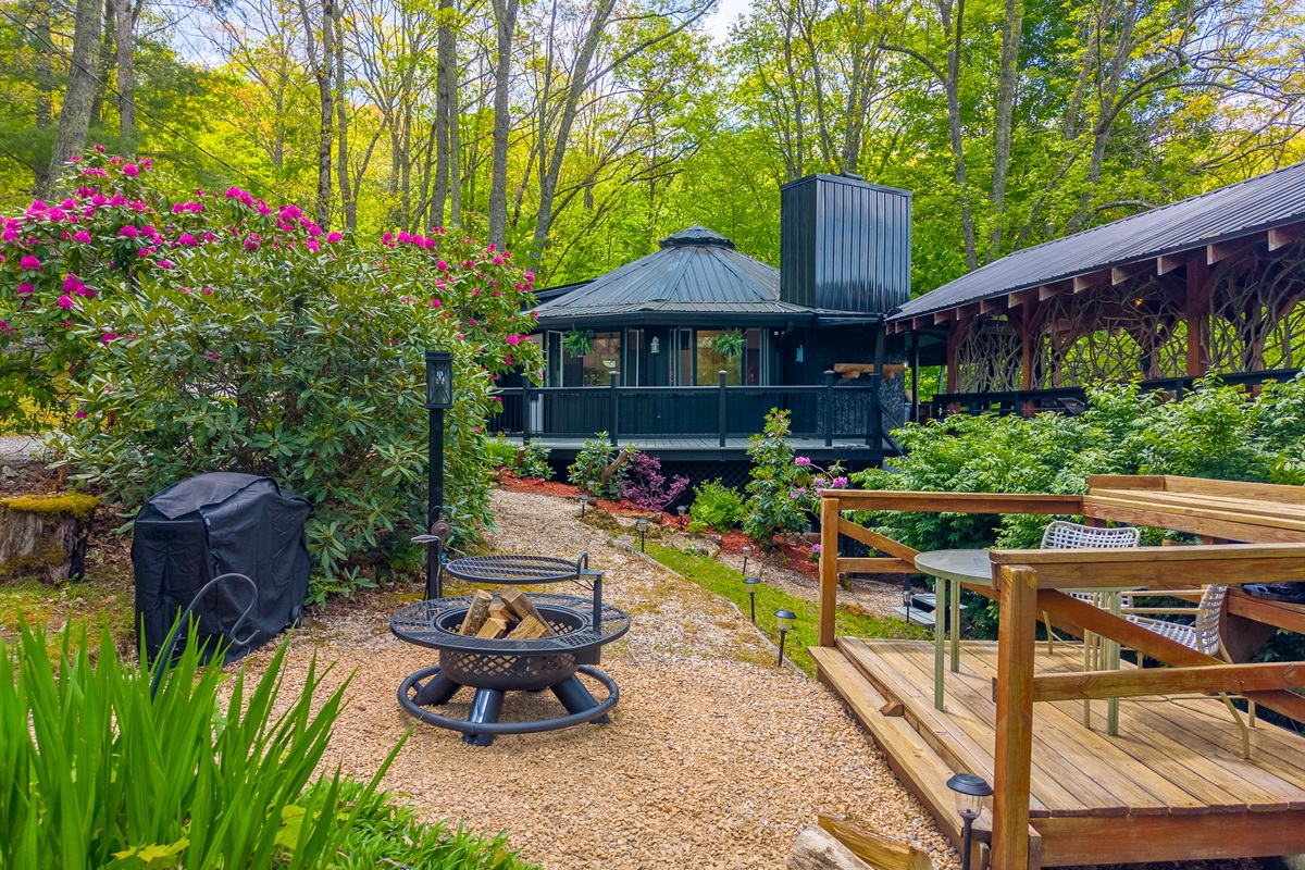 Check Out Our Cozy Fire Pit Area Amongst All The Beautiful Floiage 