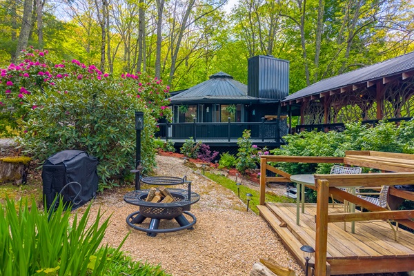 Check Out Our Cozy Fire Pit Area Amongst All The Beautiful Floiage 