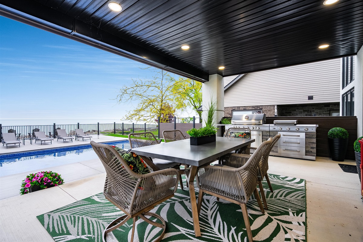 Covered veranda with outdoor kitchen and dining.