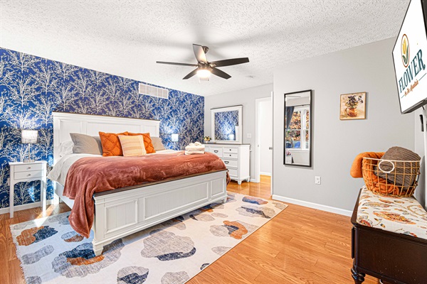 The main floor master bedroom is a luxurious retreat that boasts a king-size bed with a luxury pillowtop mattress and high-quality linens. Sink into the plush bedding and enjoy a peaceful nigh