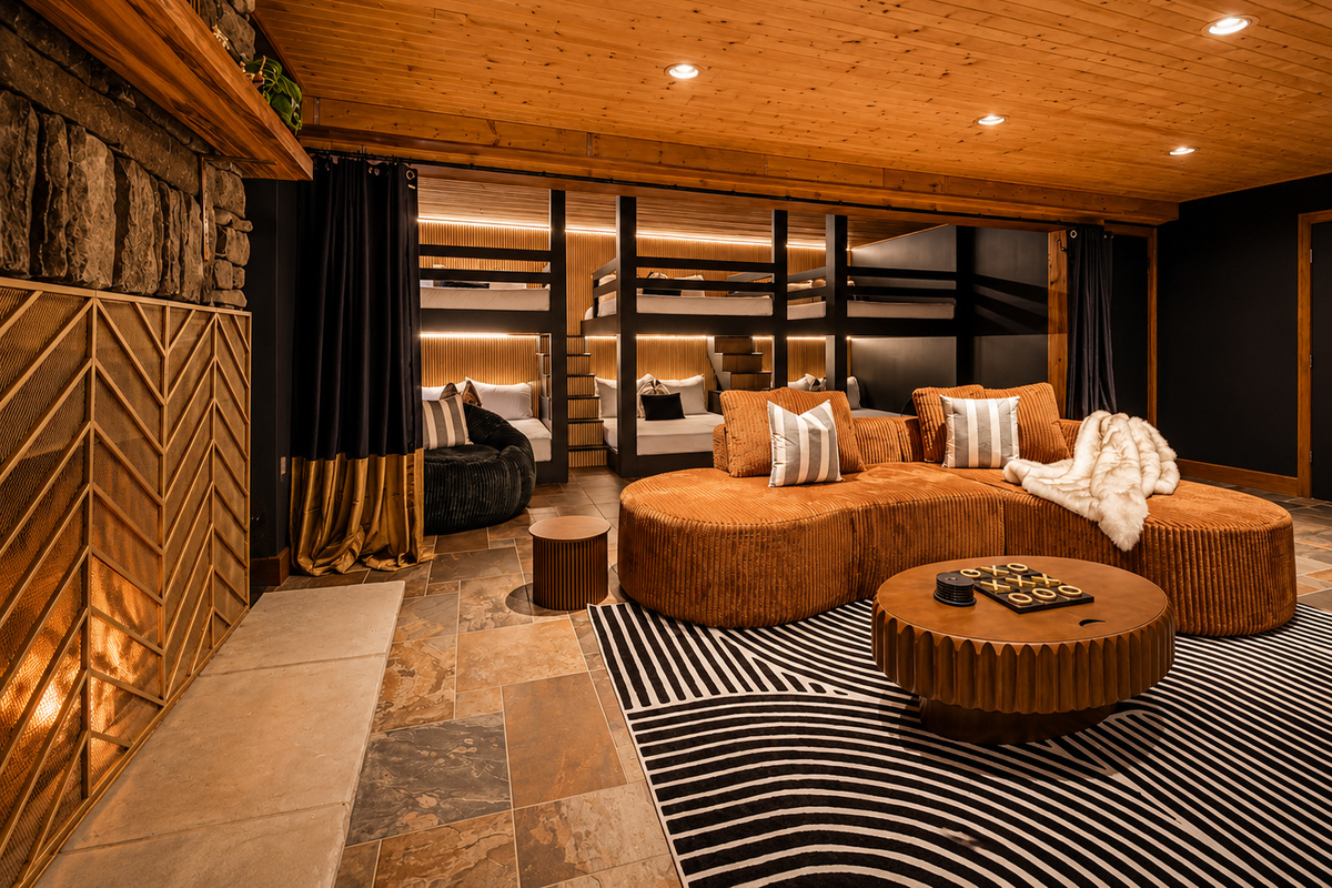 {Bunk Lounge} Three queen-over-queen bunks pair with a cozy fireside hangout space for families and larger groups.