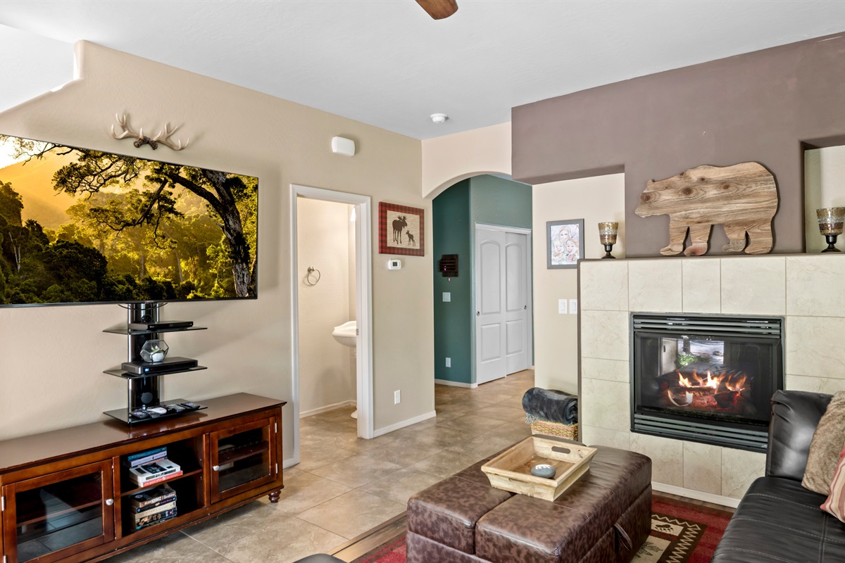 Enjoy the warm fireplace and comfortable seating in this inviting living room, perfect for relaxing after a day exploring Flagstaff.