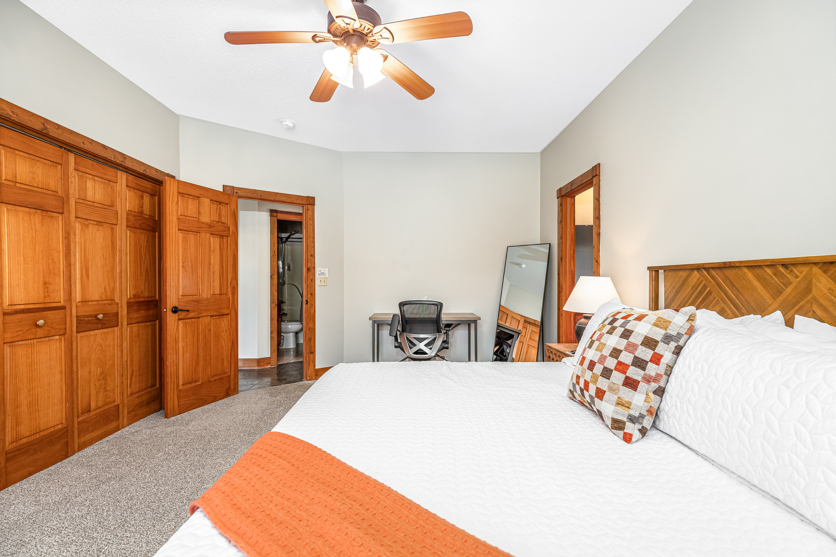 The Primary Bedroom has a king bed with full ensuite bathroom, one of two bedrooms located on the main floor. For those that need to get some work done, a desk is provided.