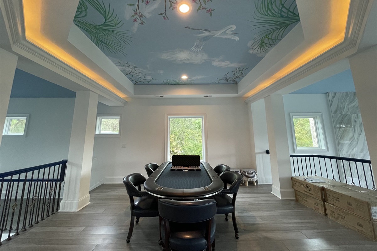 Host “Vegas night” on this 10 person poker table under a custom painted ceiling