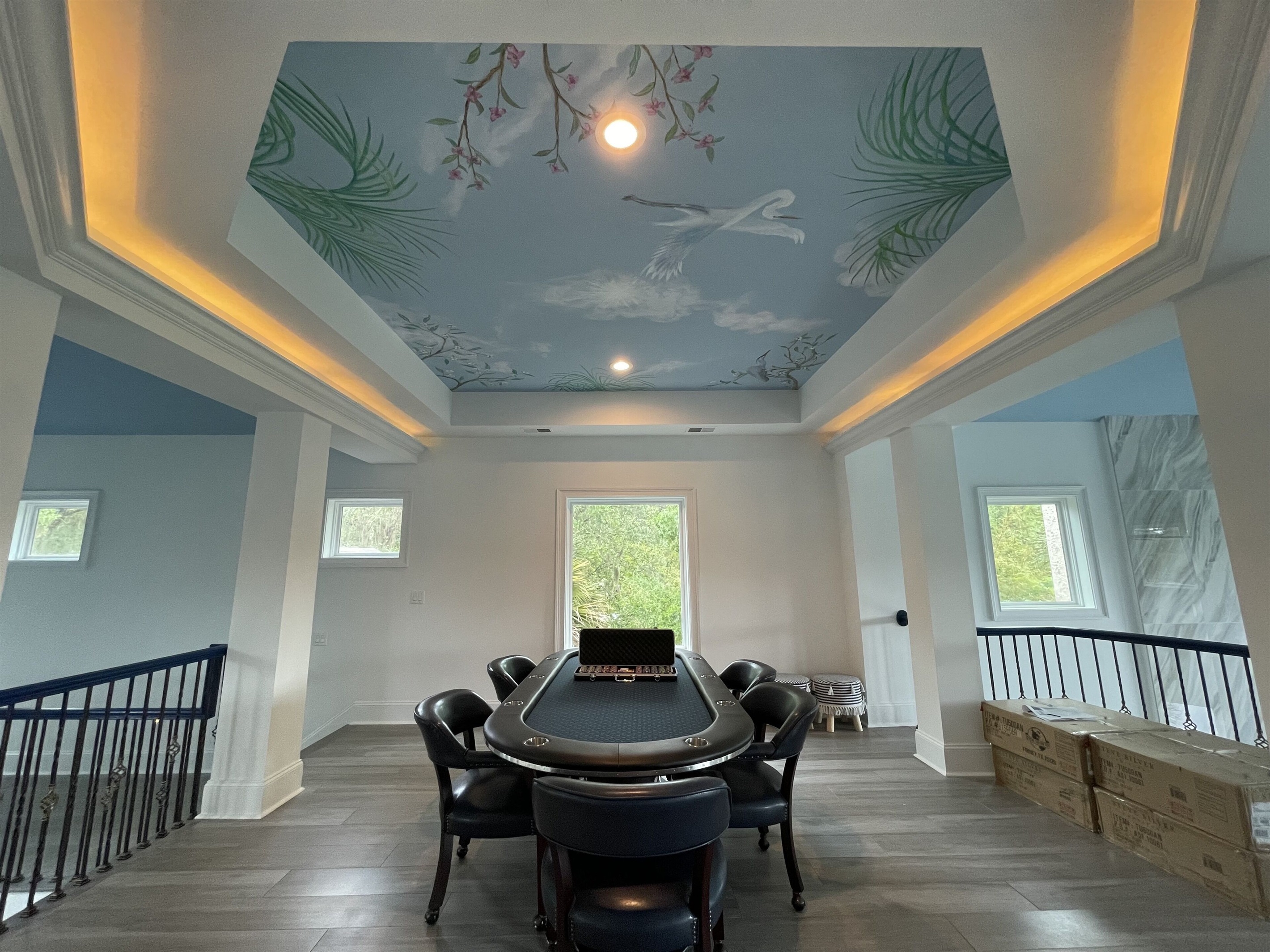 Host “Vegas night” on this 10 person poker table under a custom painted ceiling