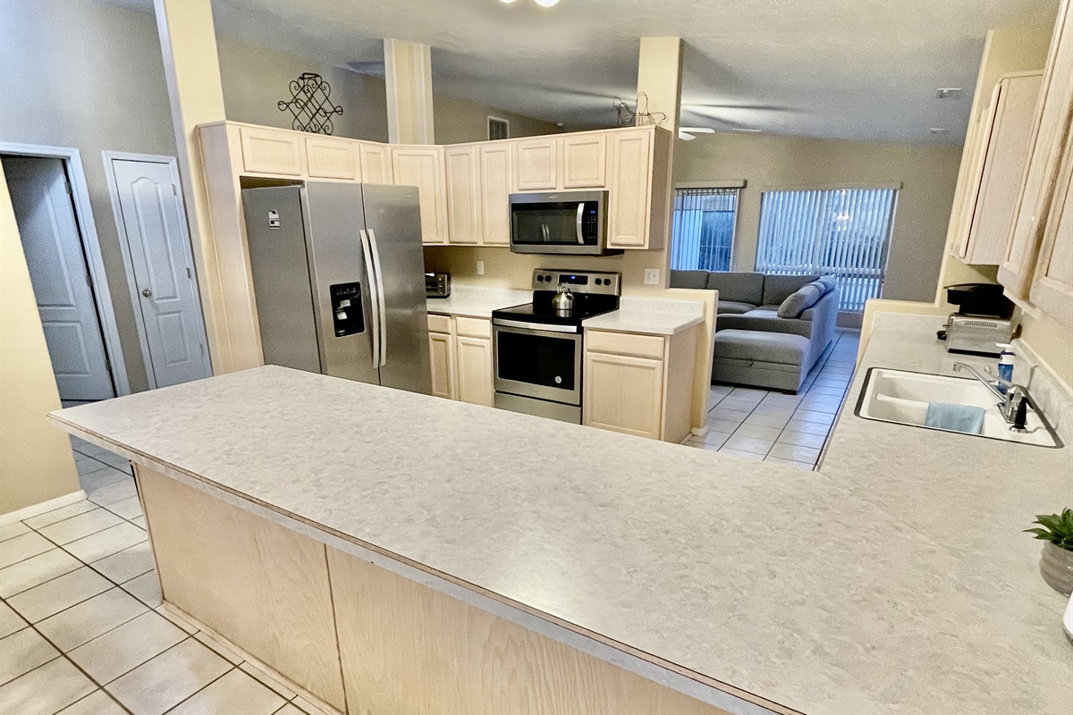 The spacious kitchen boasts ample counter space, stainless steel appliances, and all the essentials you need to whip up a gourmet meal with ease.