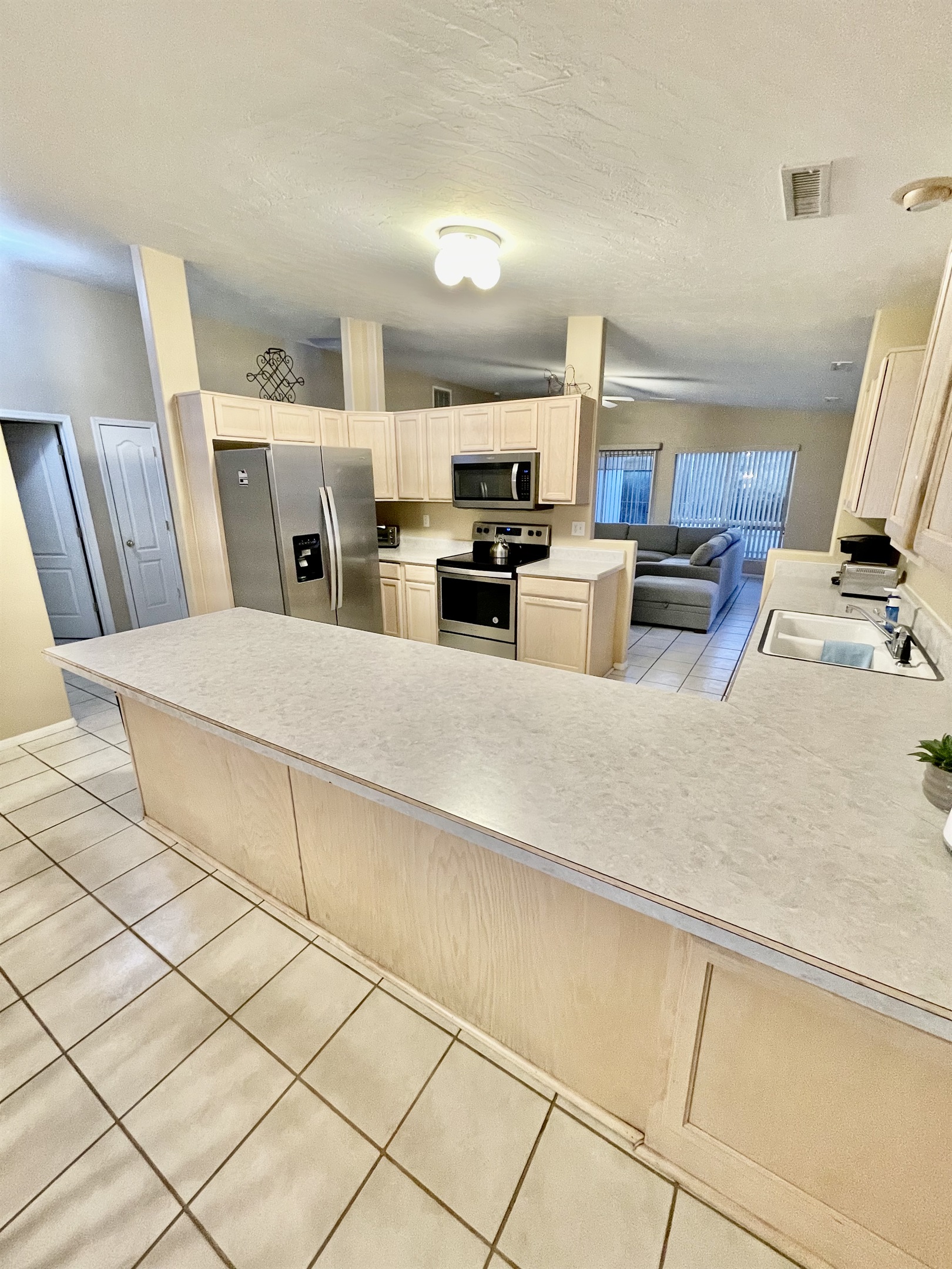 The spacious kitchen boasts ample counter space, stainless steel appliances, and all the essentials you need to whip up a gourmet meal with ease.