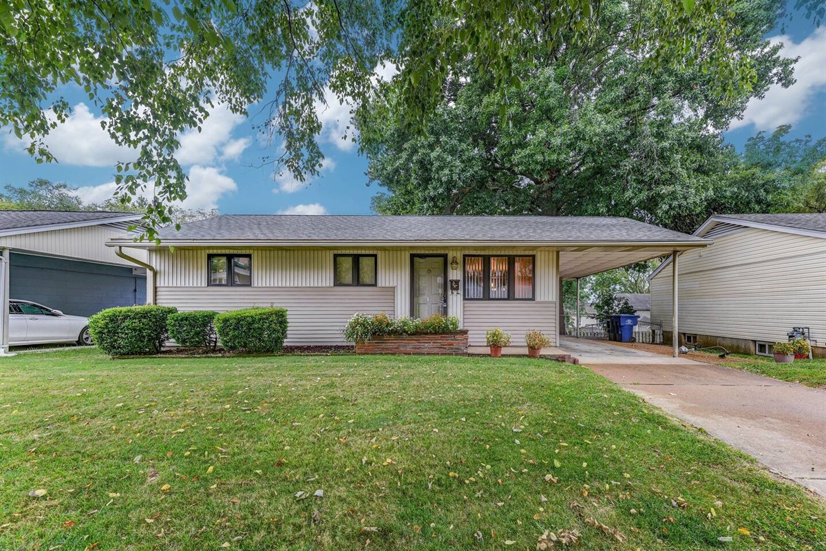 Street view - parking on street, driveway, and under carport