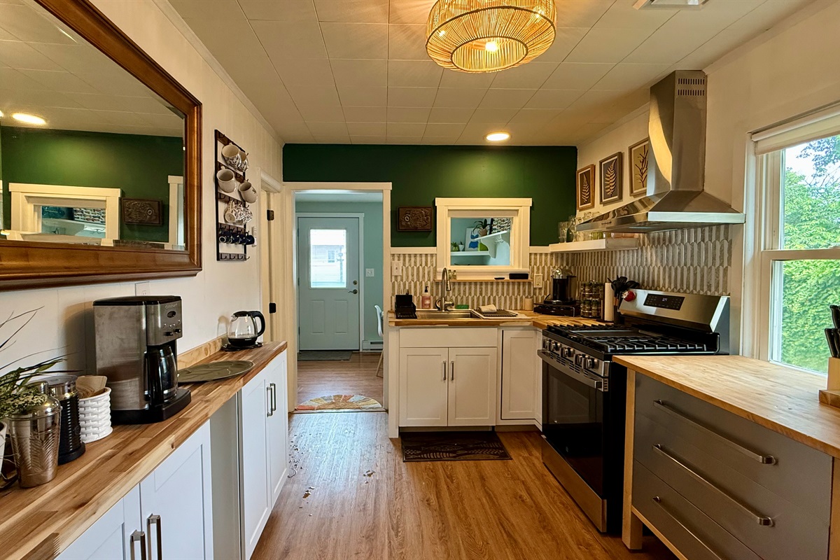 full coffee bar with espresso machine, drip coffee, and electric kettle 