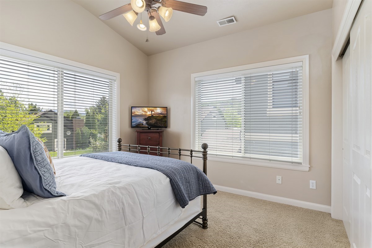 Comfortable bedroom with charming décor, additional sleeping space, and lovely views.