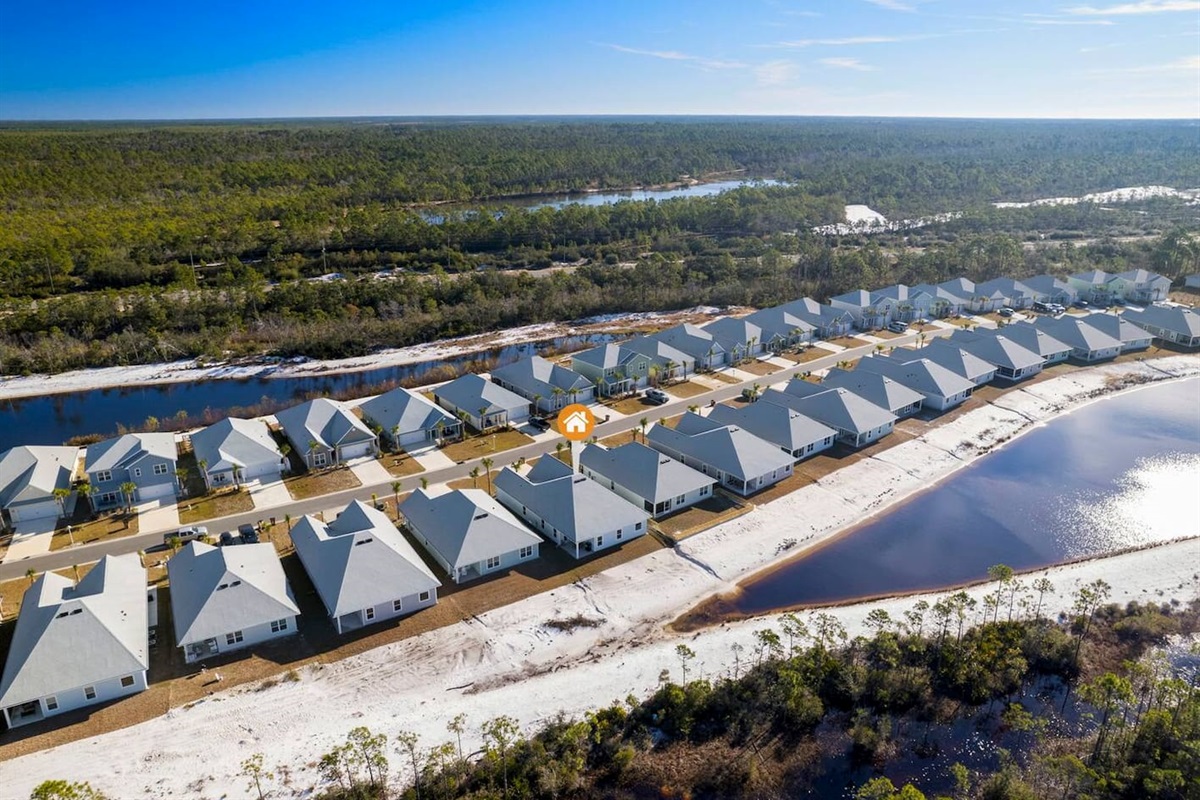 Aerial view of a peaceful coastal community surrounded by nature and water views.