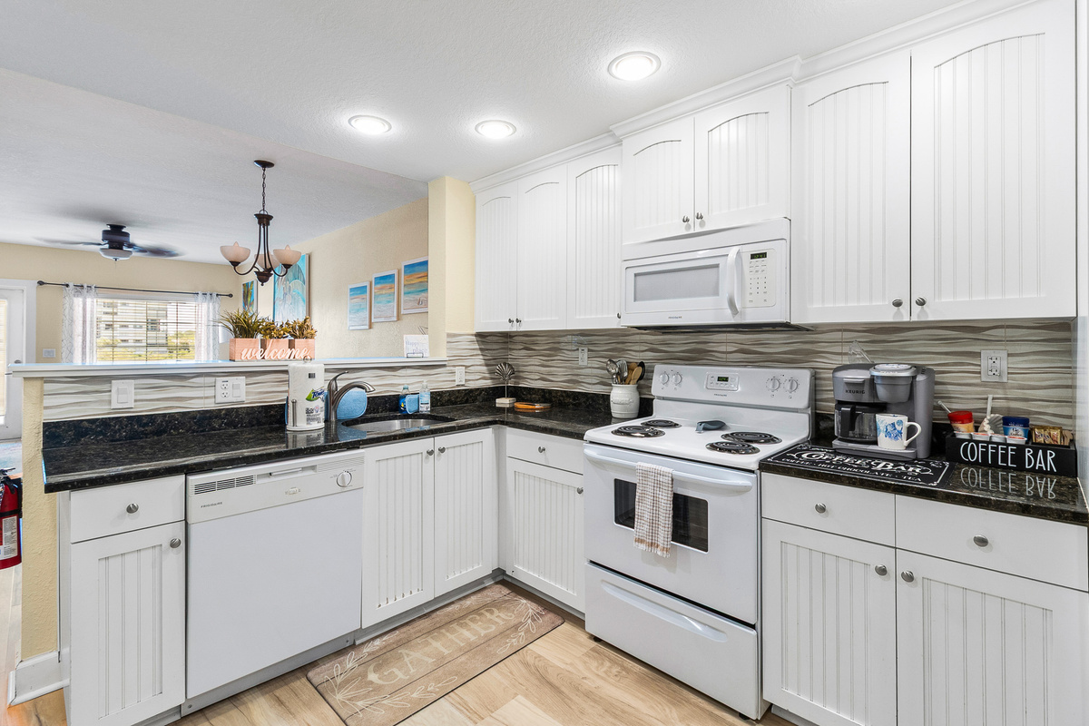 Kitchen, fully stocked with cooking/eating/drinking utensils.