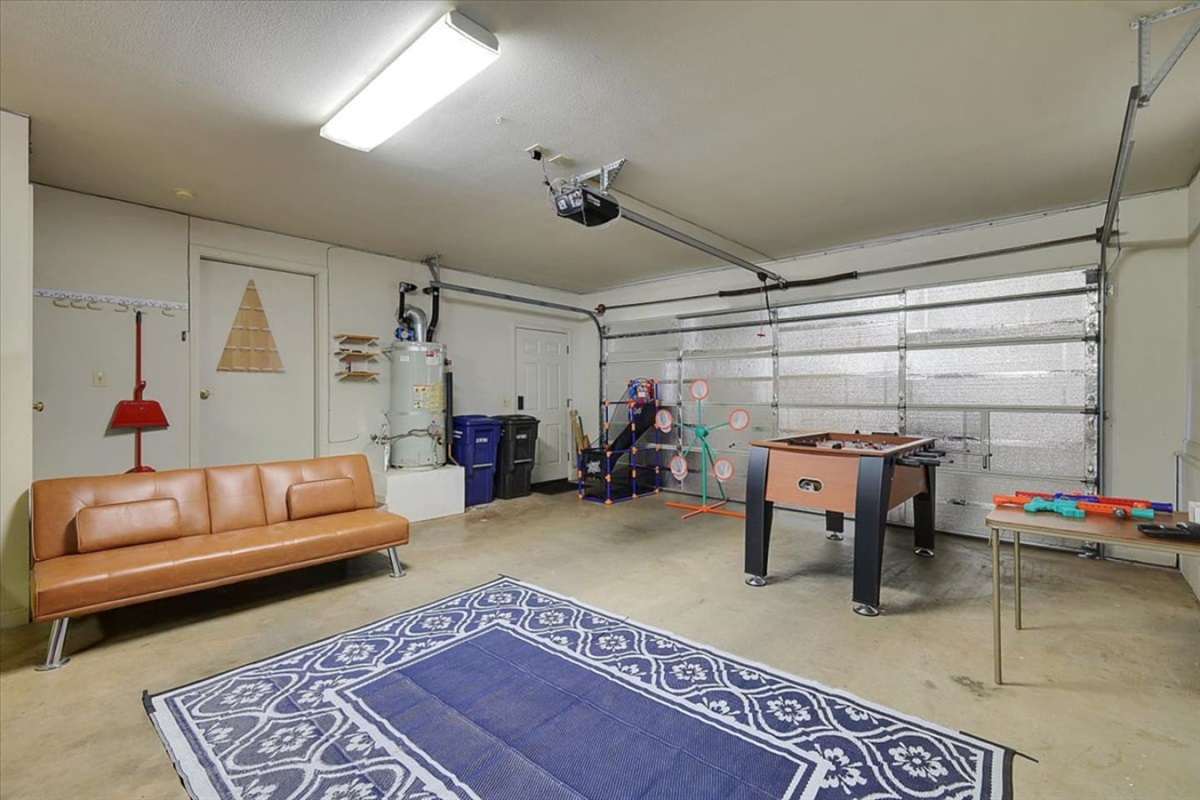 Game room with arcade games, basketball toss, sofa seating, and extra space to hang out.
