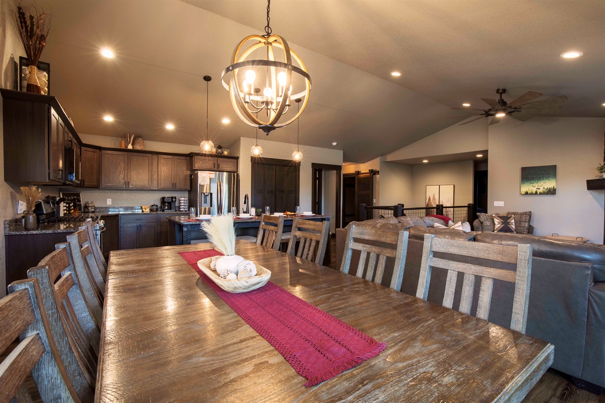 Enjoy a hearty meals at the rustic wooden dining table at "On The Rocks," illuminated by a stylish chandelier. 