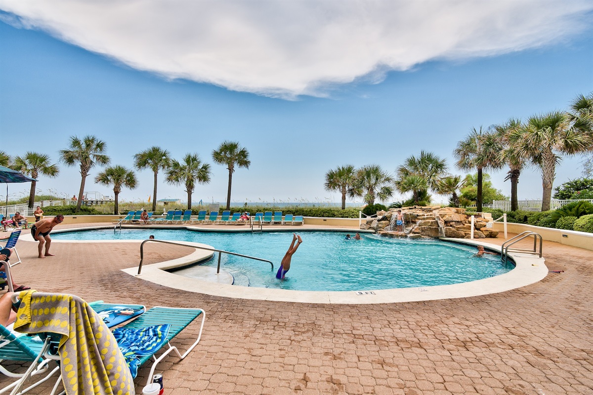 Large, Heated Seasonally, Resort Style Pool with plenty of lounge seating overlooking the Gulf of Mexico + a Hot Tub