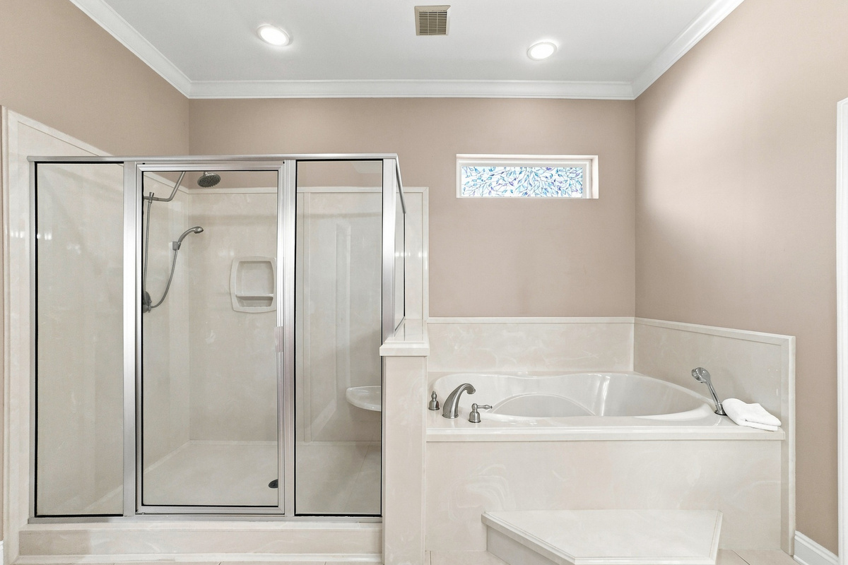Spa-style bath with a soaking tub and separate glass shower