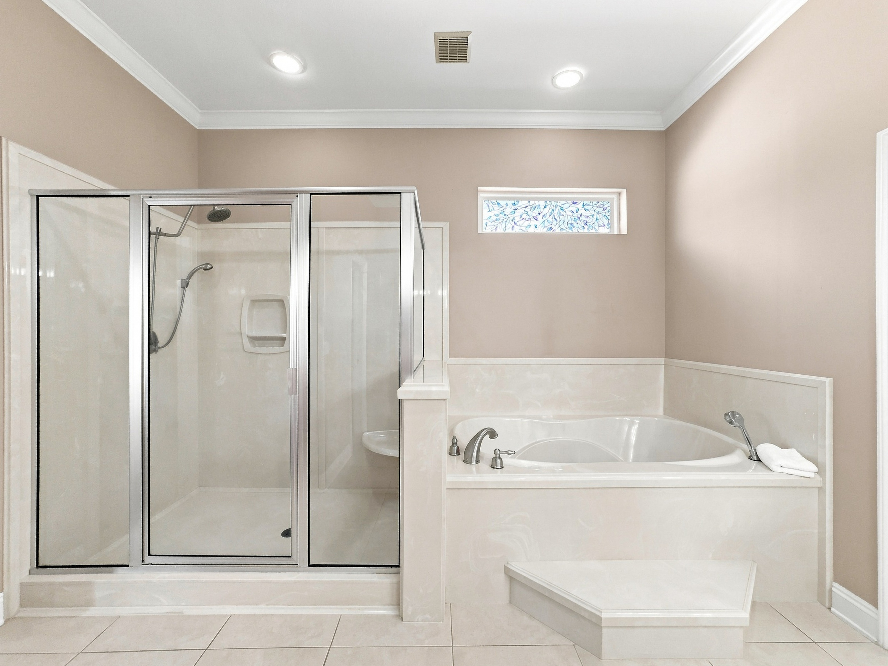Spa-style bath with a soaking tub and separate glass shower