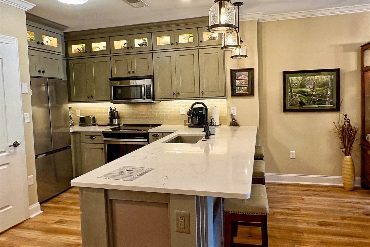 Bar lowered to counter height. Counter depth refrigerator with filtered water dispenser inside door.