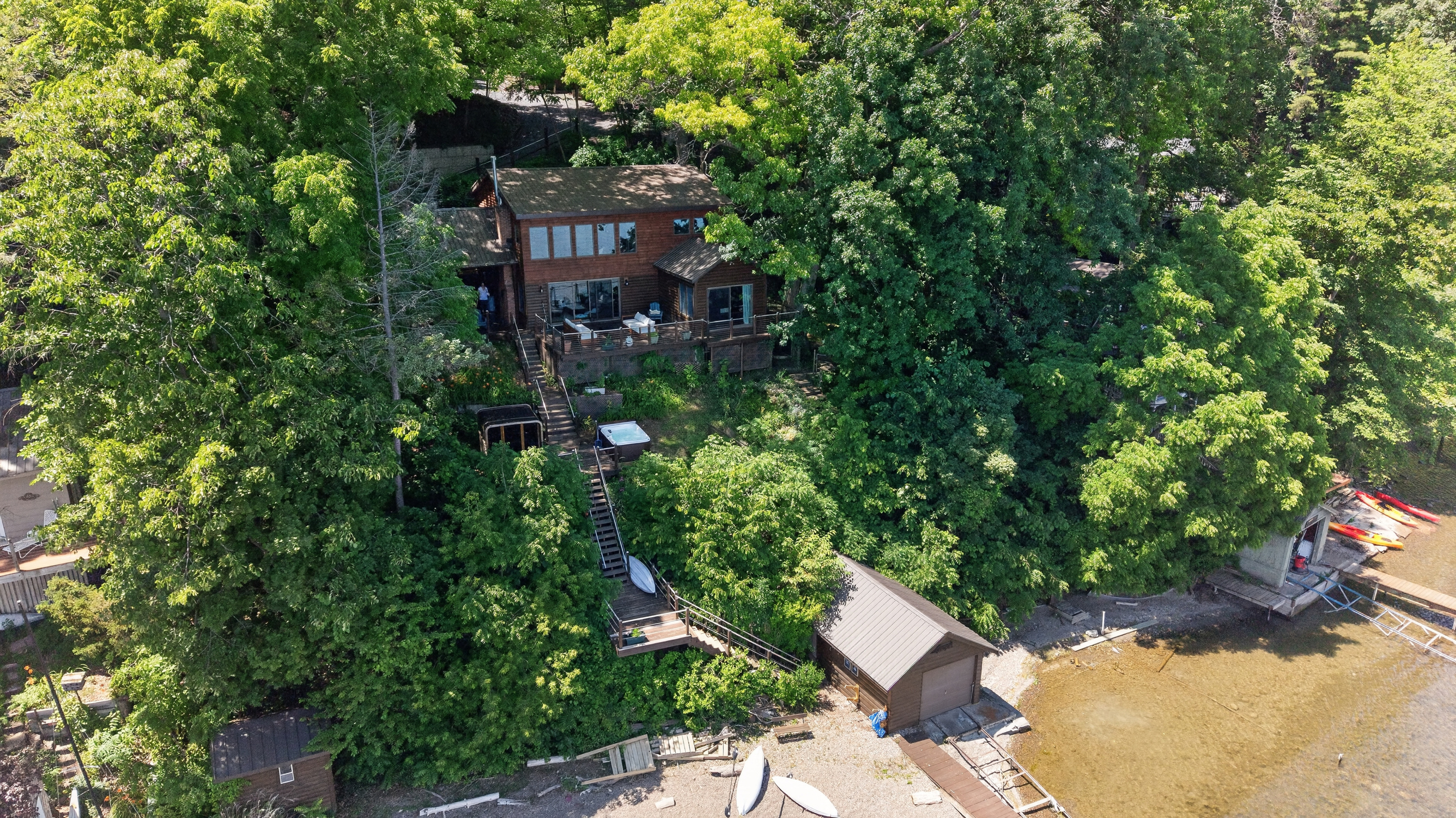 Home surrounded by dense lakeside trees