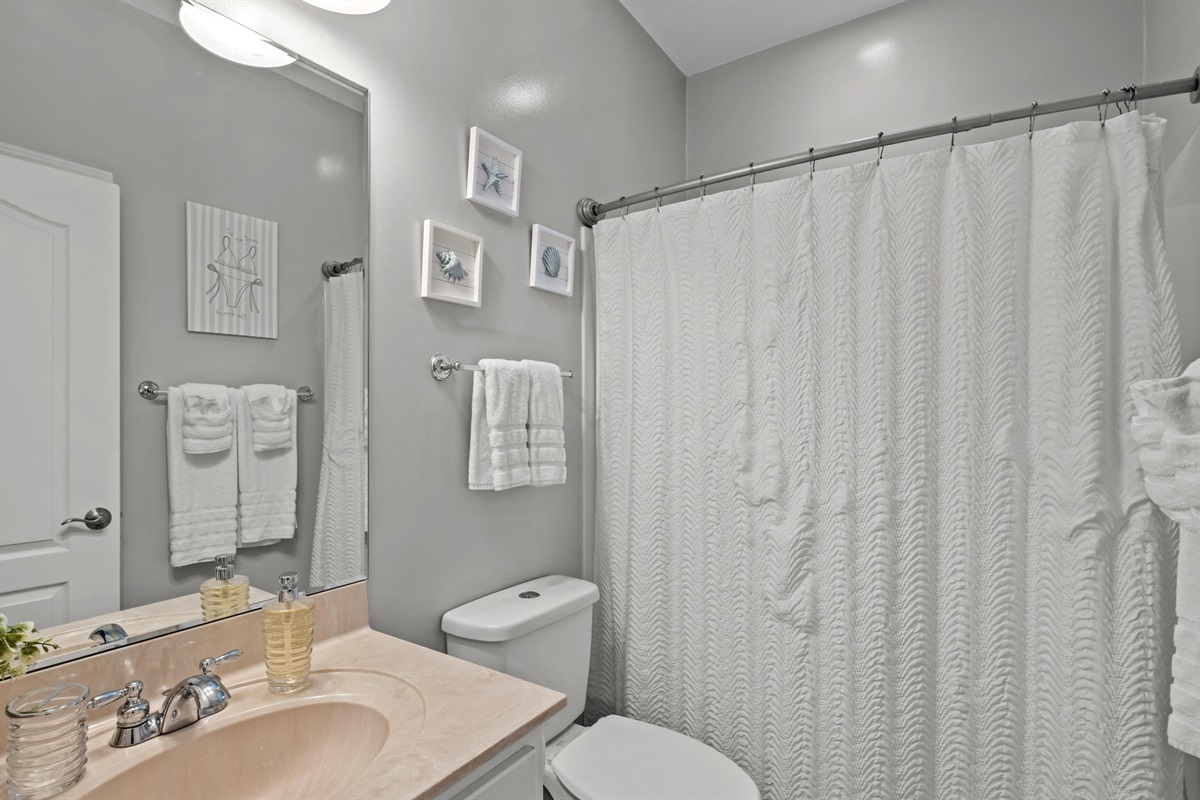 Clean, calm, and beachy — this extra bathroom is situated between the two extra bedrooms, the perfect place to refresh and recharge.
