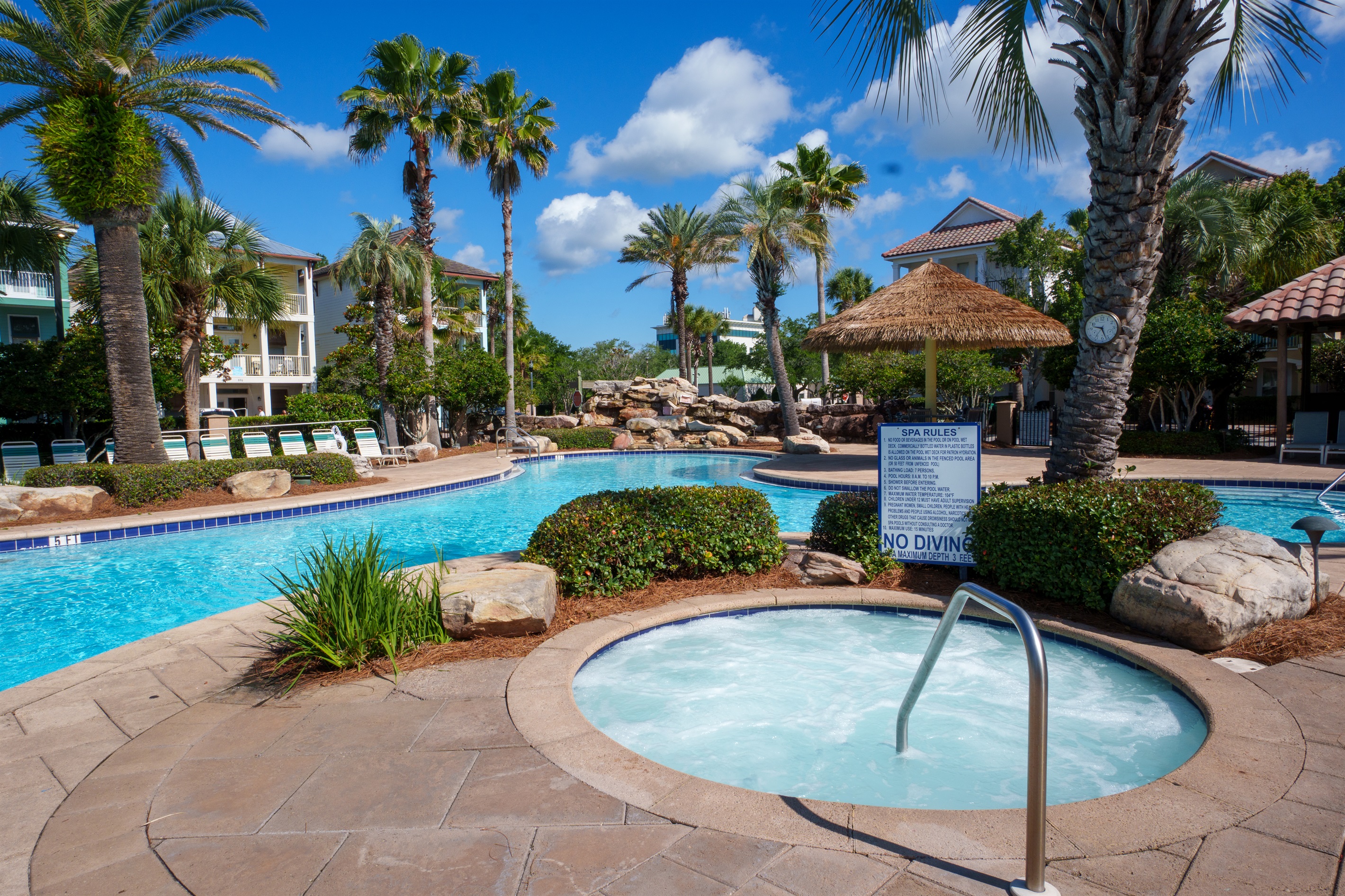 Relax and unwind in the community hot tub surrounded by palm trees